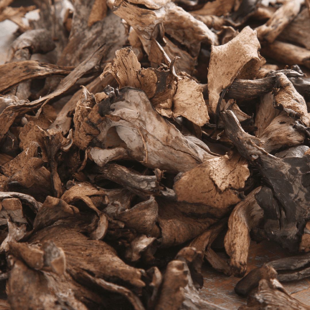 Close-up photograph of dried black trumpet mushrooms showing their distinctive funnel-shaped structure and dark brown coloration.