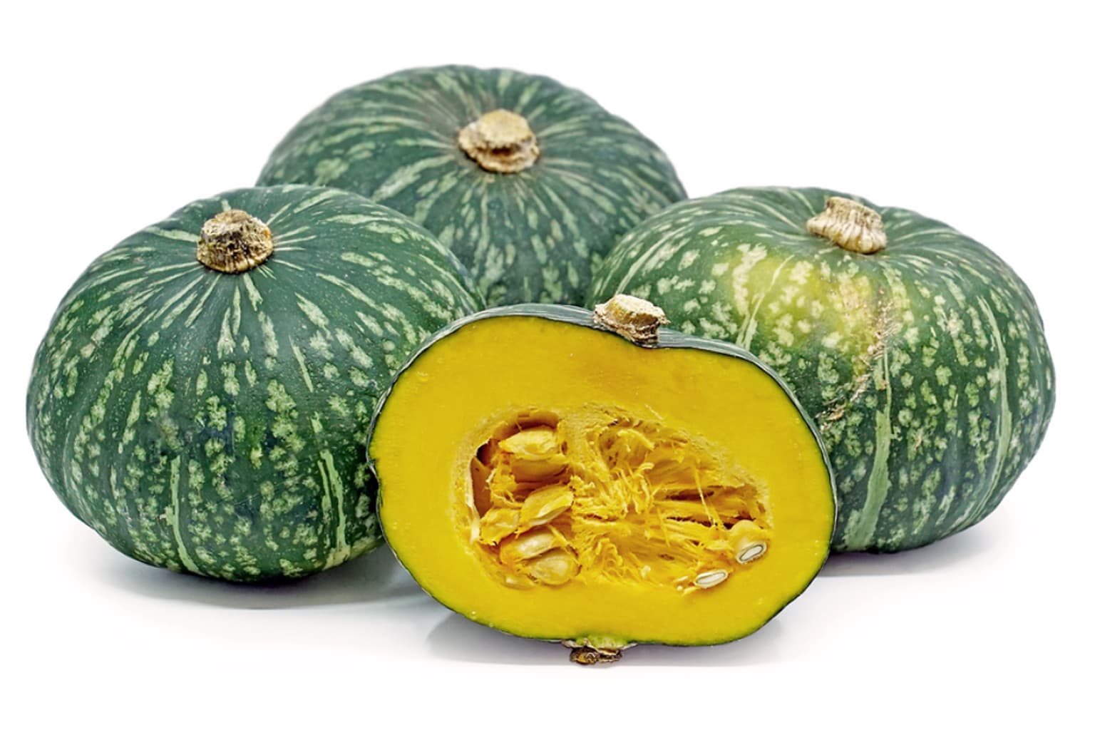 Three whole green kabocha squashes with one cut in half to reveal bright yellow flesh and seeds inside, displayed on a white background.