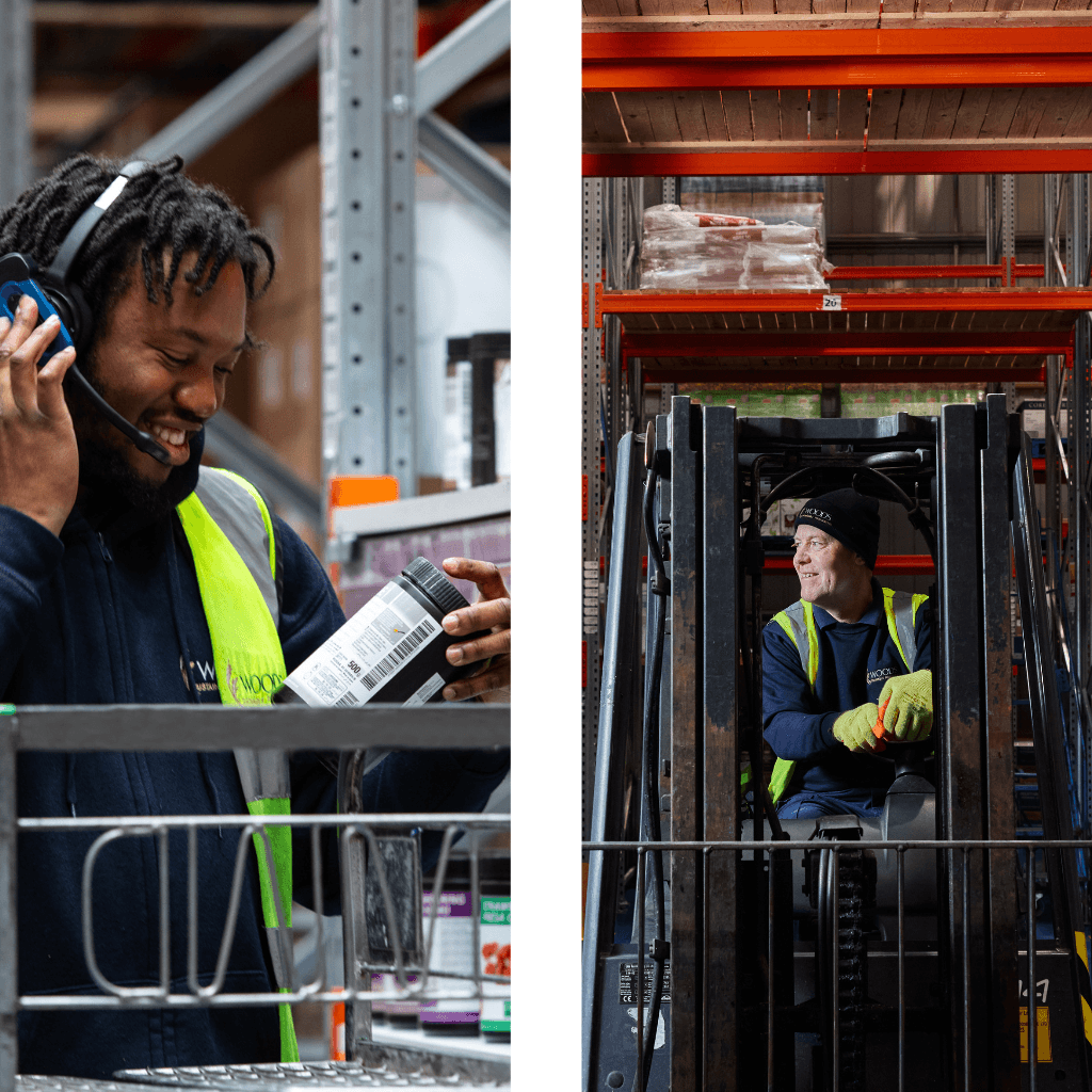 Two warehouse workers wearing high-visibility vests and safety equipment managing packaged goods on industrial racking in a foodservice storage facility.